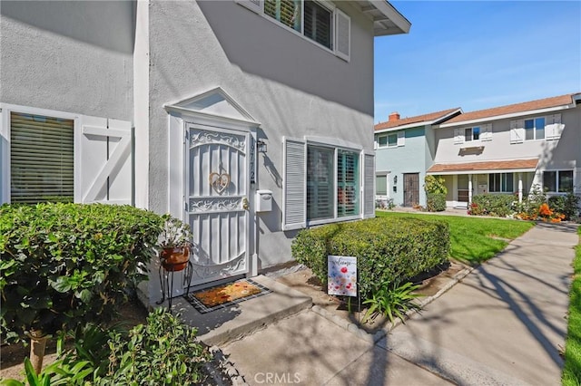 entrance to property with stucco siding