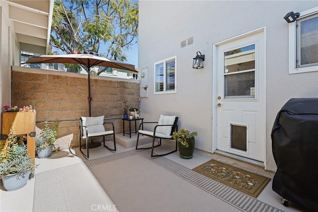 view of patio / terrace featuring fence, visible vents, and grilling area