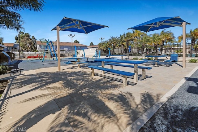 view of property's community with fence and playground community