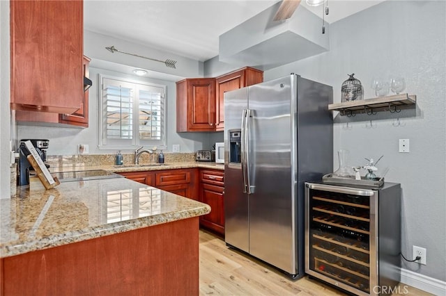 kitchen with light stone counters, beverage cooler, a ceiling fan, light wood-type flooring, and stainless steel refrigerator with ice dispenser