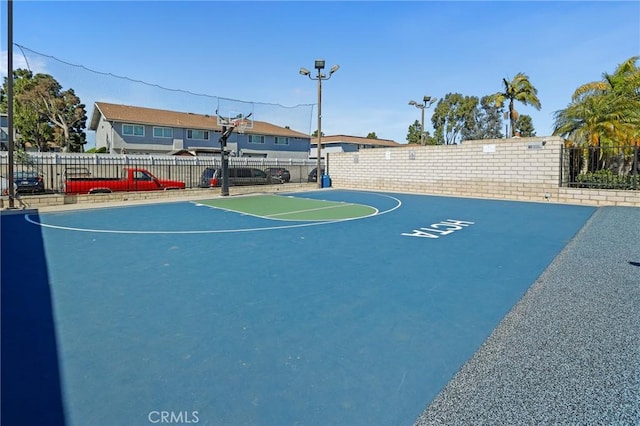 view of basketball court featuring community basketball court and fence