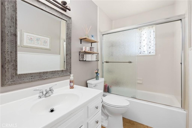 full bath with toilet, combined bath / shower with glass door, and vanity