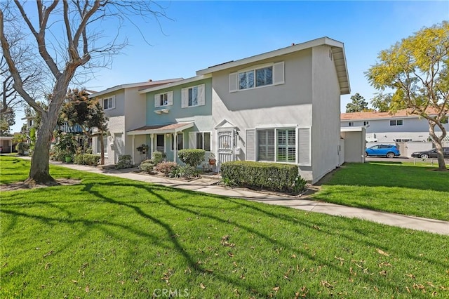 view of front of house with a front yard and stucco siding