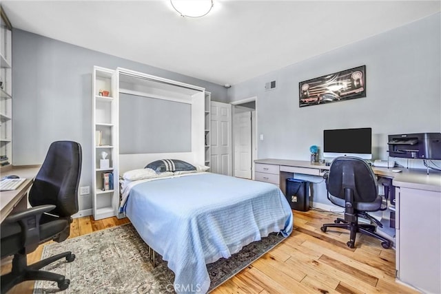 bedroom featuring visible vents and light wood finished floors