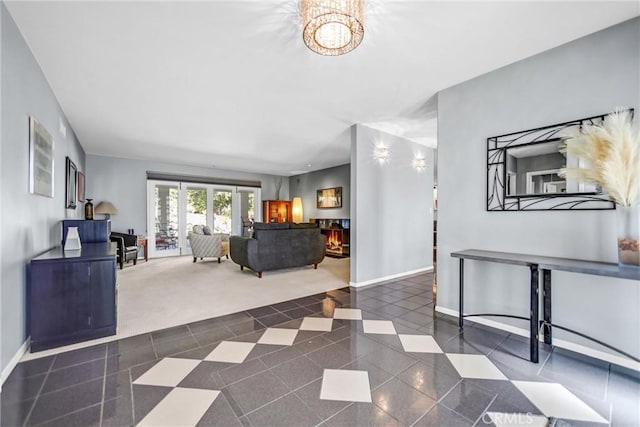 carpeted living area featuring tile patterned flooring and baseboards