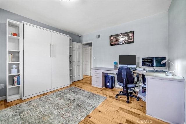 office space with wood finished floors and visible vents