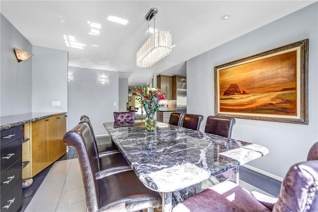 dining space with baseboards and light tile patterned floors