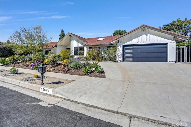 view of front of property featuring a garage, concrete driveway, and board and batten siding