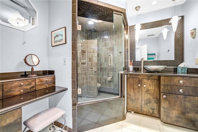 bathroom featuring a shower stall, vanity, and tile patterned floors