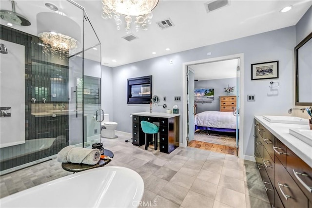 bathroom featuring a stall shower, visible vents, a sink, and an inviting chandelier