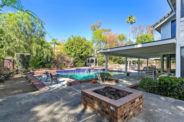 pool featuring an outdoor fire pit, a patio, and a gazebo