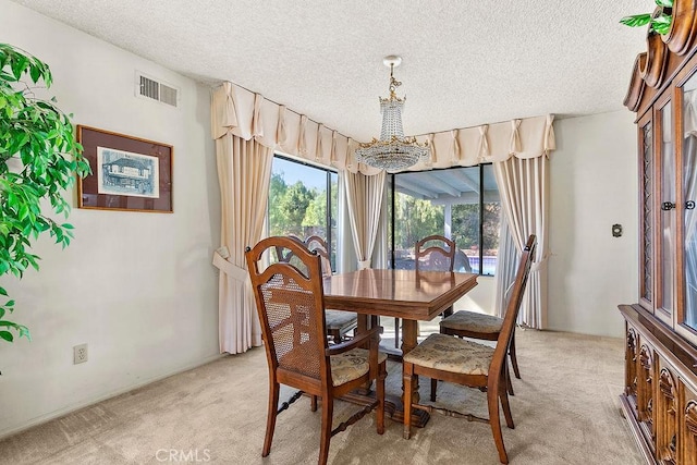 dining room with light carpet, a wealth of natural light, and visible vents