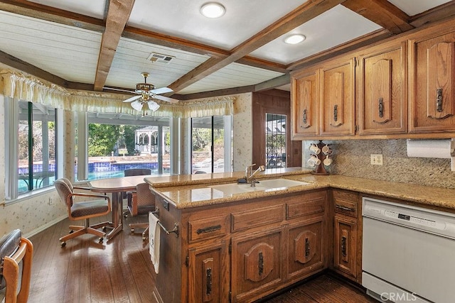 kitchen with wallpapered walls, visible vents, coffered ceiling, dishwasher, and a sink