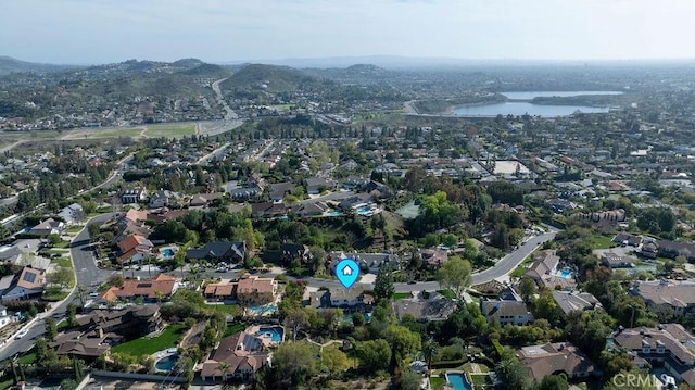 drone / aerial view featuring a water view and a residential view