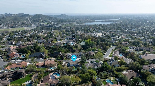 bird's eye view featuring a water view and a residential view