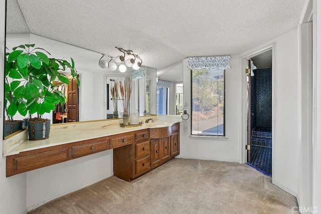 bathroom with a textured ceiling and vanity