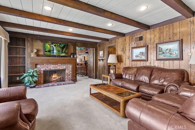 carpeted living area featuring wooden walls, visible vents, a brick fireplace, beam ceiling, and recessed lighting