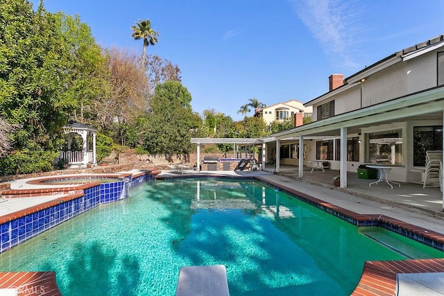 outdoor pool featuring a pergola, a patio, and an in ground hot tub