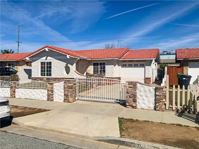 view of front of home featuring a fenced front yard, stucco siding, an attached garage, driveway, and a tiled roof