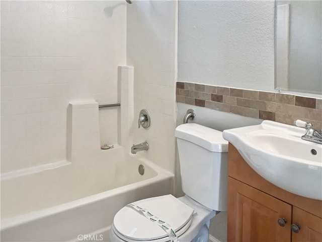 full bathroom featuring washtub / shower combination, vanity, toilet, and tile walls