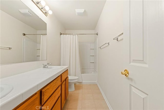 bathroom with tile patterned flooring, visible vents, toilet, double vanity, and a sink