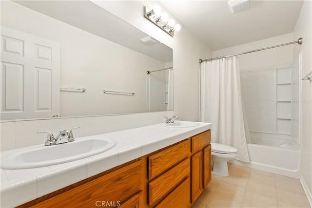 full bathroom with double vanity, a sink, tile patterned flooring, shower / bath combination with curtain, and toilet