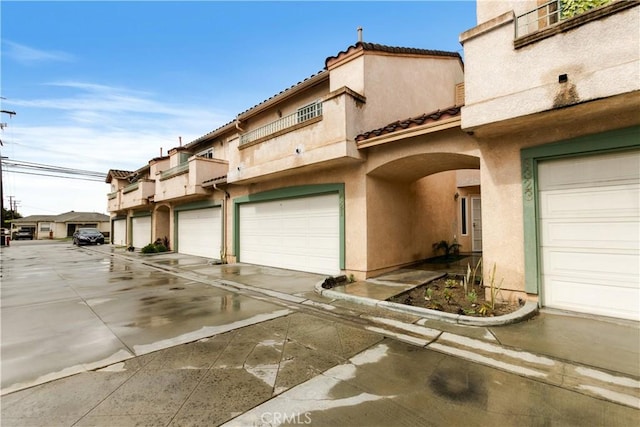 exterior space featuring stucco siding and a tiled roof