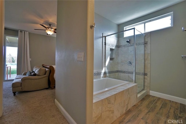 full bathroom with a stall shower, baseboards, a garden tub, and ensuite bath