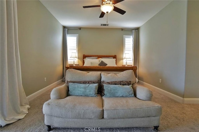 carpeted bedroom with visible vents, baseboards, and ceiling fan