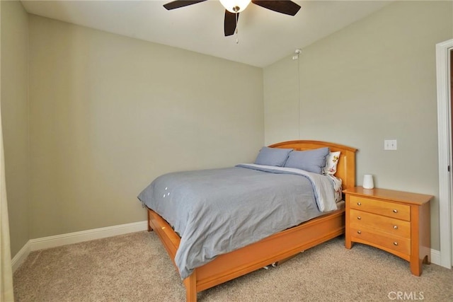 bedroom featuring light carpet, ceiling fan, and baseboards