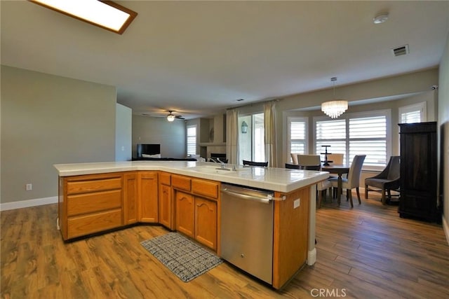 kitchen featuring dishwasher, dark wood-type flooring, open floor plan, and visible vents