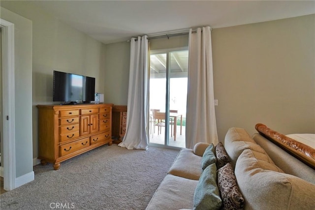 carpeted living area featuring baseboards