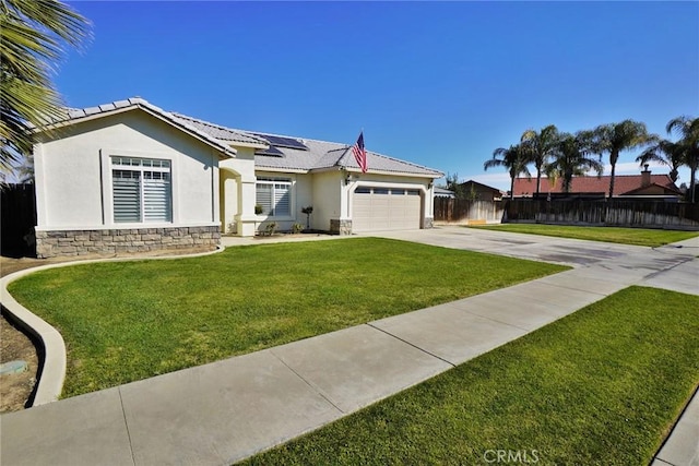 single story home with driveway, an attached garage, fence, roof mounted solar panels, and stucco siding