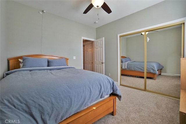 bedroom with carpet floors, a closet, baseboards, and a ceiling fan