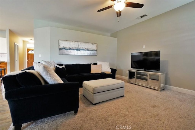 living room with a ceiling fan, carpet flooring, visible vents, and baseboards