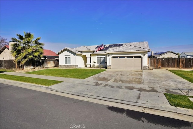 view of front of home with a garage, a front yard, a tile roof, and fence