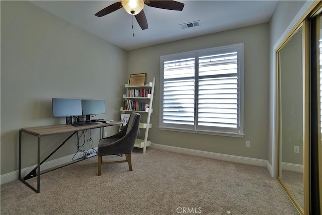 carpeted office space with visible vents, plenty of natural light, baseboards, and ceiling fan