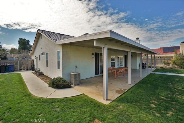 view of side of property with a yard, a fenced backyard, a patio, and stucco siding