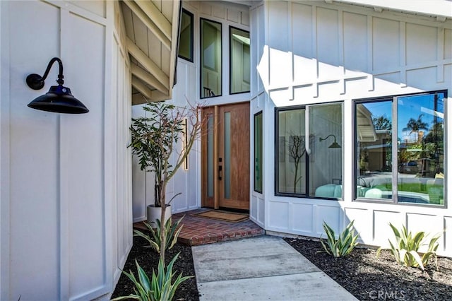 doorway to property featuring board and batten siding