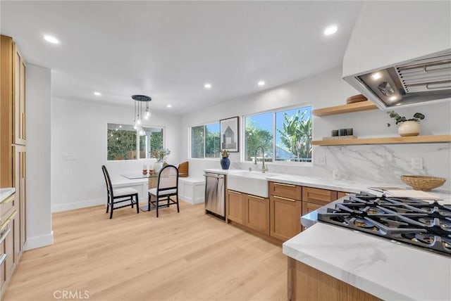 kitchen with open shelves, extractor fan, stainless steel dishwasher, a sink, and light wood-style flooring