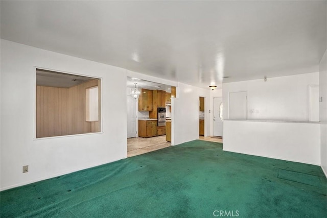 unfurnished living room featuring light colored carpet