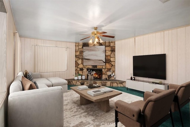 living room featuring a fireplace and ceiling fan