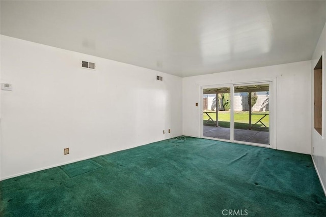 carpeted empty room featuring visible vents