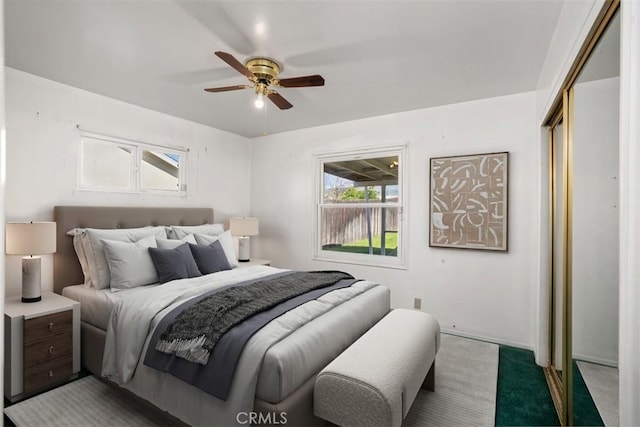 bedroom featuring ceiling fan, a closet, and carpet