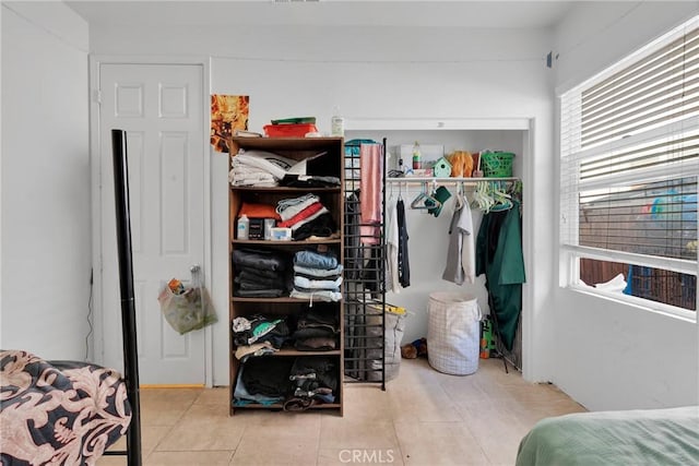 tiled bedroom featuring a closet