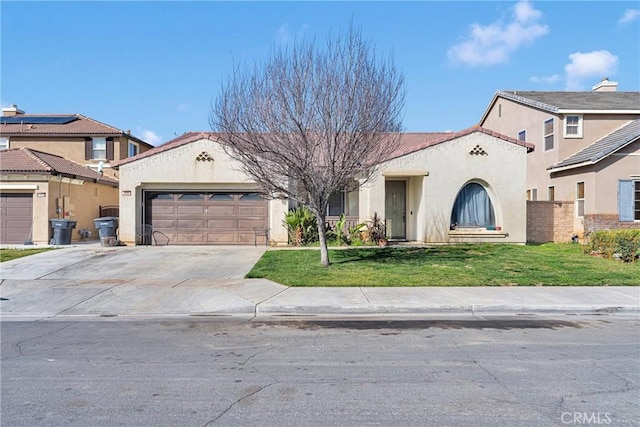 mediterranean / spanish home featuring a garage, concrete driveway, a front lawn, and stucco siding