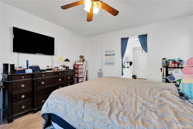 bedroom featuring light tile patterned floors and a ceiling fan