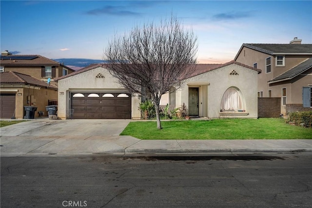 mediterranean / spanish-style house featuring a tile roof, stucco siding, an attached garage, a front yard, and driveway