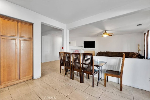 dining area featuring a ceiling fan, visible vents, and light tile patterned flooring