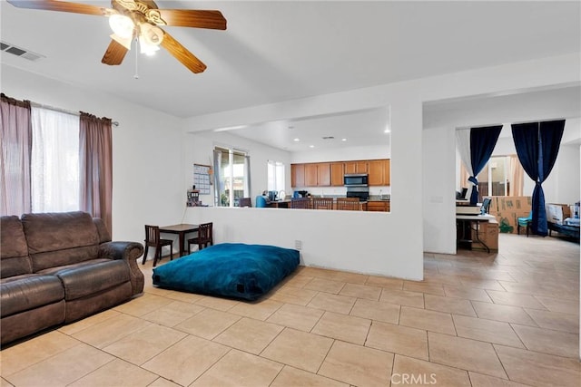 living area featuring recessed lighting, light tile patterned flooring, visible vents, and a ceiling fan